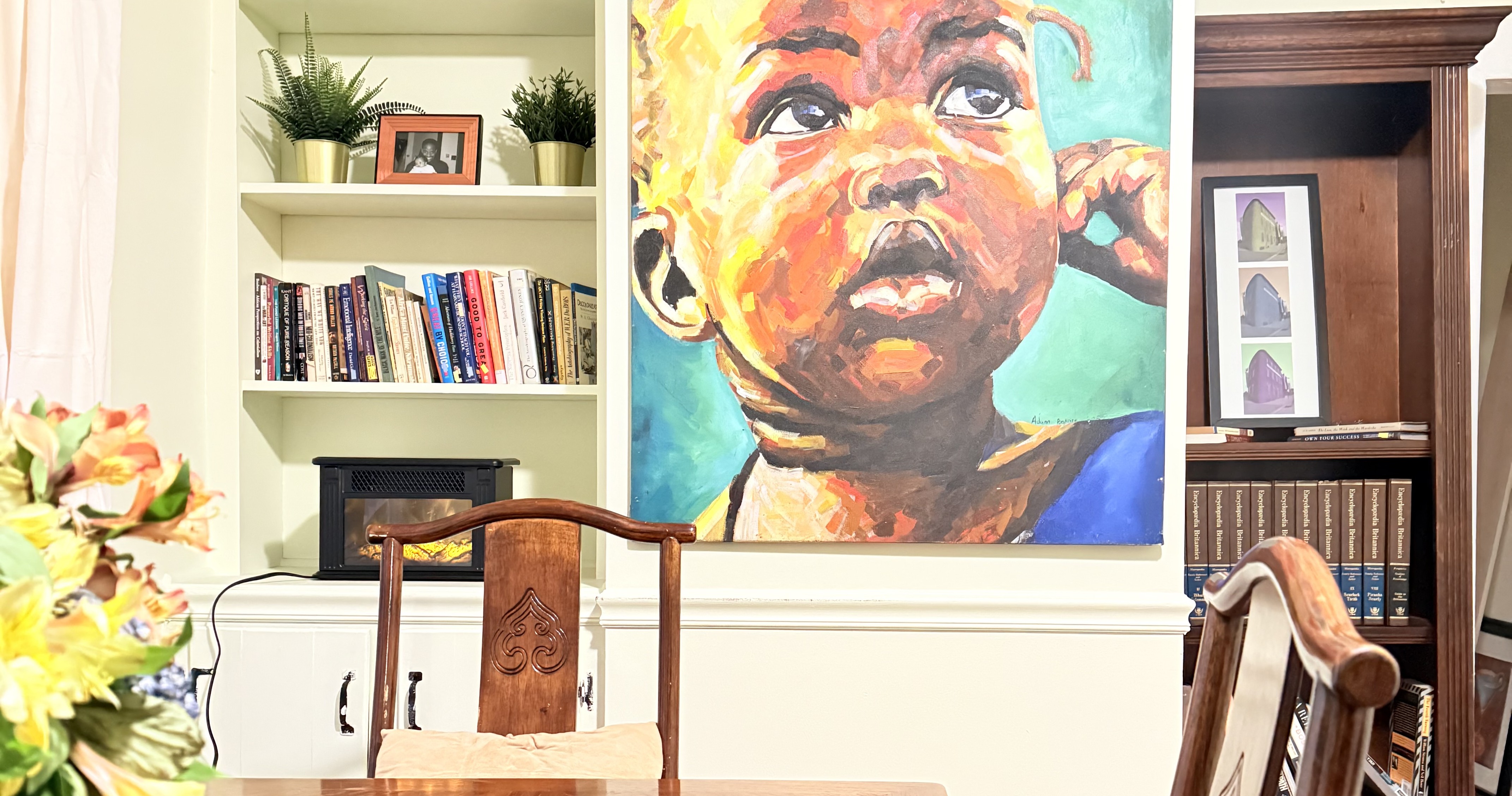 The long table at 817 N Howard Street, beneath the wall portrait